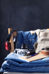 Denim jeans and old retro concept at old wooden chair near black wall background texture