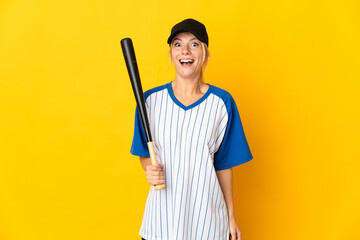 Young Russian woman isolated on yellow background playing baseball and with surprise and shocked facial expression