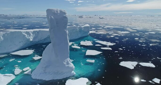 Sun reflection at arctic ocean with melting iceberg aerial. Environment ecological issue of global warming and rising seas problem. Polar climate change at sunny winter day. Cinematic ecology scene