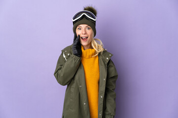 Skier Russian girl with snowboarding glasses isolated on purple background with surprise and shocked facial expression