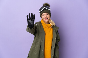 Skier Russian girl with snowboarding glasses isolated on purple background happy and counting four with fingers