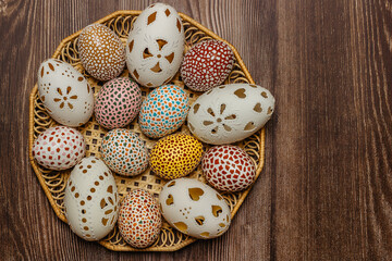 Happy Easter.Colorful hand painted decorated Easter eggs, CZ kraslice. Handmade Easter eggs in wooden basket.Spring decoration background. Festive tradition for Eastern European countries.