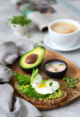 Healthy breakfast whole wheat toasted bread with avocado and poached egg