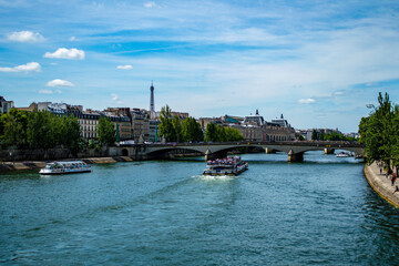 Paris, France - July 21, 2019: View of river Seine with passenger boats in Paris, France