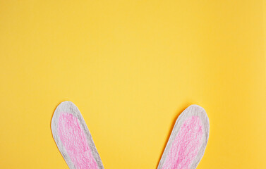 funny paper bunny ears on a yellow background