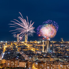Fireworks in the sky of barcelona over the streets of the Eixample and Sagrada Familia