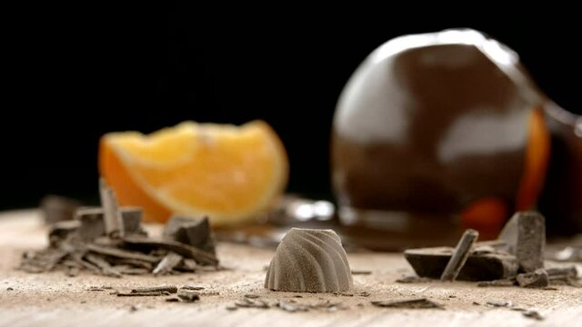 Slowmo Packshot of Praline with Oranges in the Background 