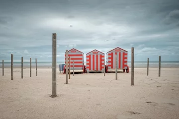 Foto op Canvas Row of colorful beach cabins on a cloudy day © Erik_AJV