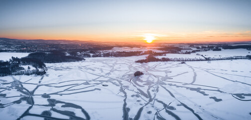 Drone shot above the Dam reservoir in Bautzen during sunset with frozen lake winter season ice snow