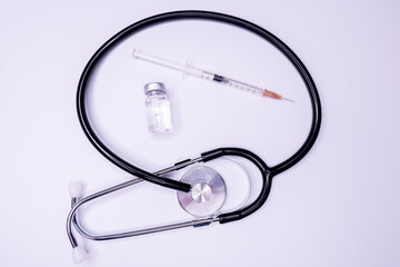 Doctor blue stethoscope for cardiac on white background with syringe.Equipment of physician for...