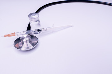 Doctor blue stethoscope for cardiac on white background with syringe.Equipment of physician for...