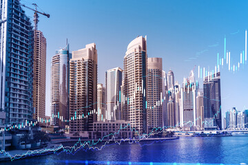 Skyscrapers of Dubai business downtown. International hub of trading and financial services of Western Asia. FOREX graph and chart concept. Double exposure. Dubai Canal waterfront.