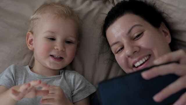 Mother And Her Child Baby Make Video Call To Their Father Or Family