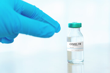 Development and creation of a coronavirus vaccine COVID-19 .Coronavirus Vaccine concept in hand of doctor blue vaccine jar. Vaccine Concept