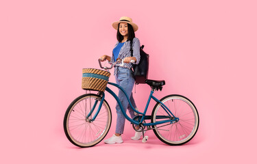 Asian woman standing with retro bicycle with wicker basket