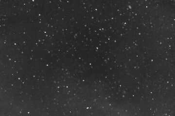 white snow on a black background, background image, selective focus, blank for the designer