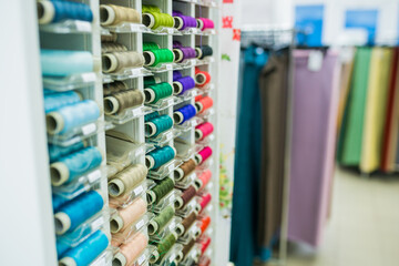 Sewing thread. thread spools background in textile store. Selective focus