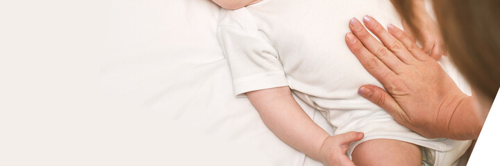 Cute small boy lying at bed. Childhood concept. Light background. Serious child. Copyspace. Stay home. Mockup. Horizontal banner. Massage. White clothes