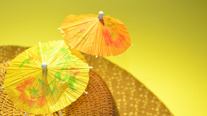Fototapeta na wymiar Yellow and orange umbrella on a yellow background.
