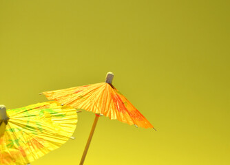 Yellow and orange umbrella on a gray-yellow background. 