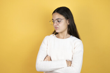 Beautiful child girl wearing casual clothes thinking looking tired and bored with crossed arms