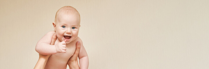 Cute small boy at mother hands. Childhood concept. Smiling child. Happy emotion. Copyspace. Stay...