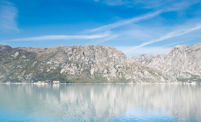 View of Bay of Kotor from the sea surrounded by mountains in Montenegro, one of the most beautiful bay in the world