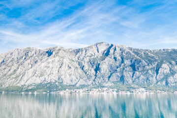 Fototapeta na wymiar View of Bay of Kotor from the sea surrounded by mountains in Montenegro, one of the most beautiful bay in the world