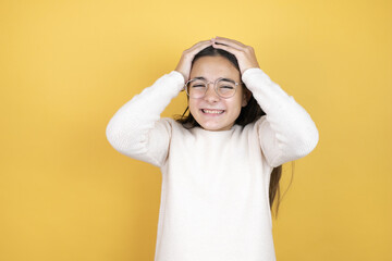 Beautiful child girl wearing casual clothes suffering from headache desperate and stressed because pain and migraine with her hands on head