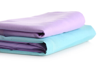 Stack of clean bed sheets isolated on white