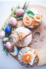 Easter Eggs and Cakes on a Wooden Board 