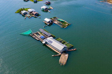 Fototapeta na wymiar Floating local Fishing Village Houseboats with Fish Farms aerial view
