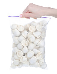 Pack of frozen dumplings in hand on white background isolation