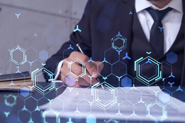 A client in dark blue suit is signing a contract to create a new software to present it in start up conference and gain investments to create a product. Technological graph over the desk.