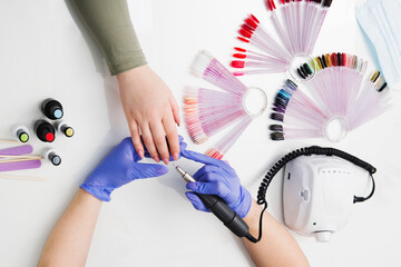 Professional hardware manicure  using electric machine in beauty salon.  nailcare at beauty salon.