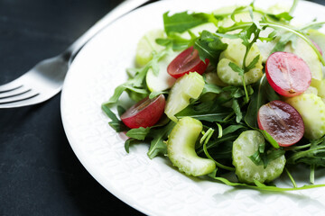 Delicious fresh celery salad on black table, closeup