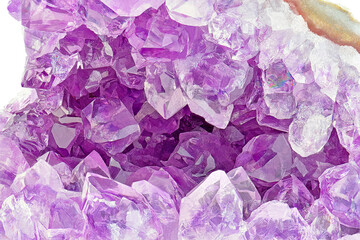 Amazing rare shape sparkly Violet Crystal Stone macro mineral surface. Purple rough Amethyst quartz Crystals geode on white background. Amethyst looks like a cave made of stone.