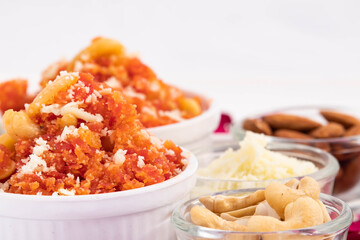 Gajar Ka Halwa Halva Or Carrot Pudding Gajrela Halua Made Of Grated Carrots Milk Cream Meetha Mava Sugar Desi Ghee Khoya Mawa Badam Kismis And Pista. White Background With Copy Space For Text