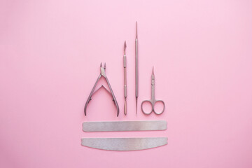 Professional set for manicure on a pink background.