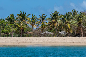 Caribbean, Grenada, Mayreau Island. Thatched roof cabanas and beach.