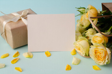 International Women's Day. 8 March, Mother's Day. Greeting Card. Decoration with gift box and yellow bouquet roses on a light background