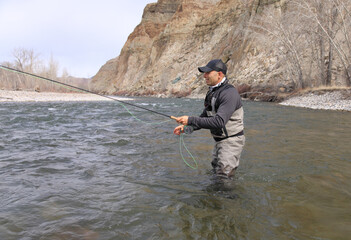 Fly fisherman casting for steelhead trout on the Salmon River in Idaho