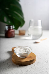 selective focus. Collagen powder in a glass container. light background. copyspace. Extra protein intake. Natural beauty and Health supplement for skin, bones, joints and intestines