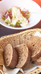 Kidney beans health salad. Dark table and white plate. Cafe menu. Green leaves and cheese fitness dinner. Organic vegetable diet. Black bread bowl. Vegan product. Fast eat.