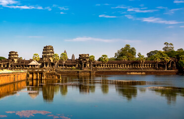 Beautiful landscape of the ancient city of Angkor Wat in Cambodia. Towers of the temple of the Kmer people with reflection in the lake. The concept of travel to the sights of ancient civilizations.