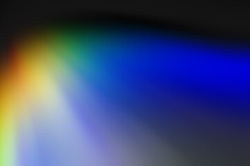 abstract composition of radial red, yellow, green, blue rays on a shadowy gray background.