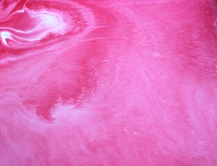 Abstract pink marble background. Acrylic paint flows freely and creates an interesting structure....