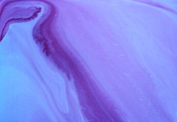 Abstract blue-lilac marble background. Acrylic paint flows freely and creates an interesting...