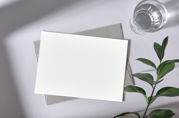 Mockup white greeting card with envelope and flower. for mock-up design template.