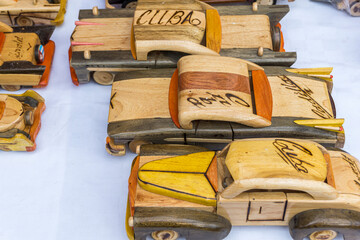 Cuban wooden miniature American vintage car models crafted by locals displayed for sale 